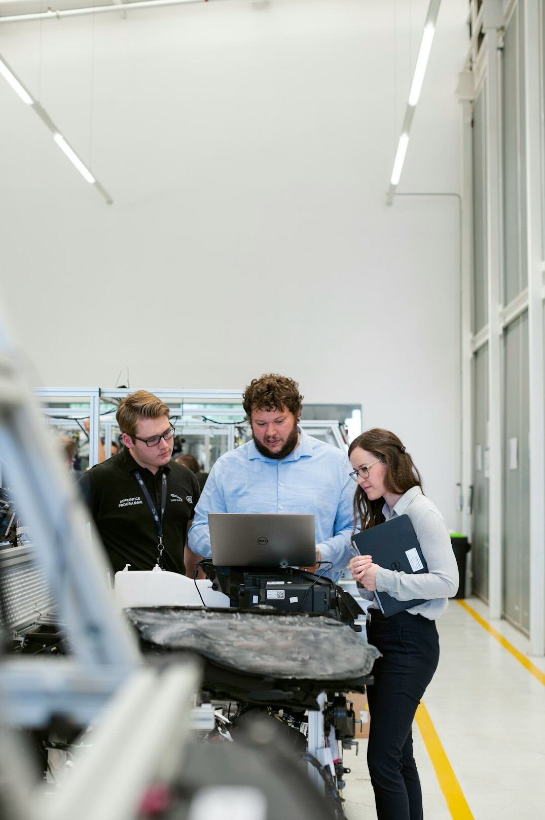 Small group of professionals discussing around a table with a laptop